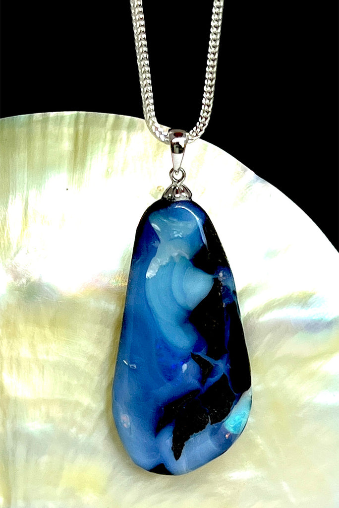 A very organic natural opal piece with strong blue colour meeting the boulder down one side, it looks like the meeting of the sea and the shore.
