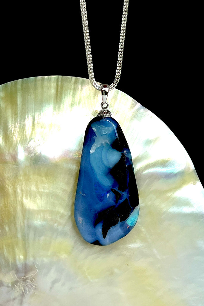 A very organic natural opal piece with strong blue colour meeting the boulder down one side, it looks like the meeting of the sea and the shore.