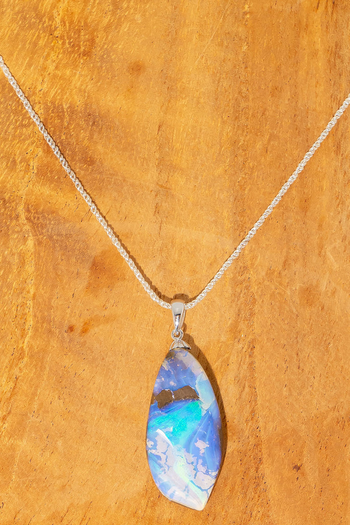 An organic natural piece featuring a small clear jelly opal detail on one side that reveals what is underneath. This piece has so much detail and depth.