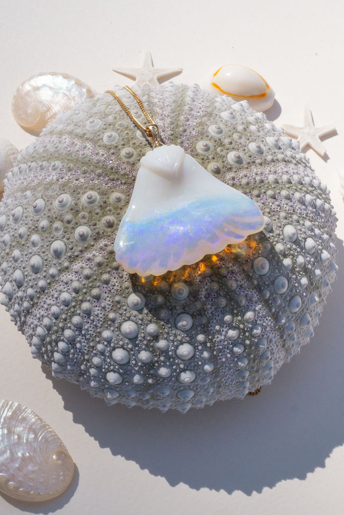 An absolute stunner, this mystical crystal opal skilfully carved into the shape of a whale tail, a dreamy and tactile opal pendant that is a one off piece.