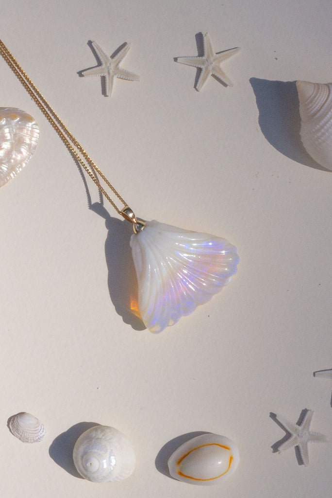 An absolute stunner, this mystical crystal opal skilfully carved into the shape of a whale tail, a dreamy and tactile opal pendant that is a one off piece.