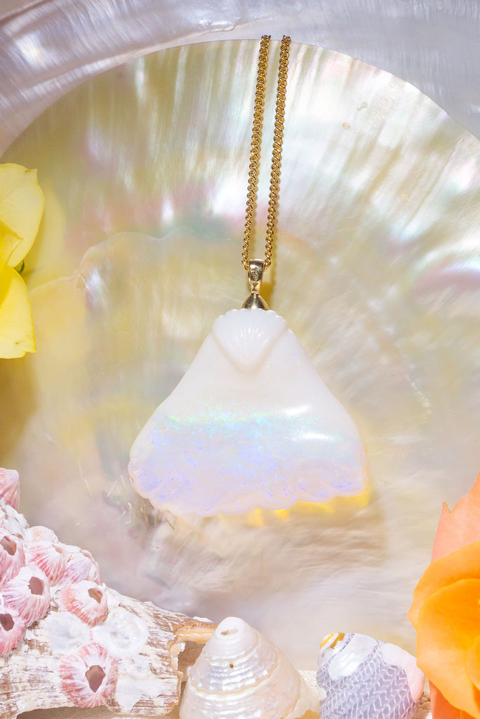 An absolute stunner, this mystical crystal opal skilfully carved into the shape of a whale tail, a dreamy and tactile opal pendant that is a one off piece.