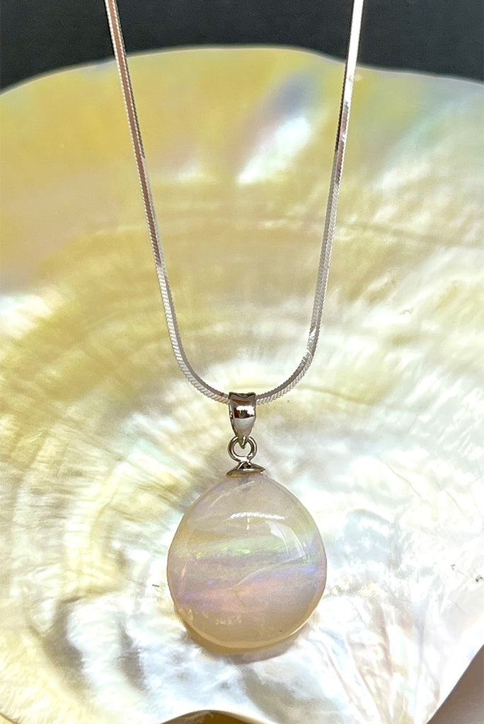 Absolute perfection, this lovely round stone looks like a pale misty moon, with soft blue, pale greeny yellow and tiny flashes of pink. The detail is across the stone and deep within, it is polished to a lovely soft finish. This piece has so much mystery. Australian Crystal Opal.