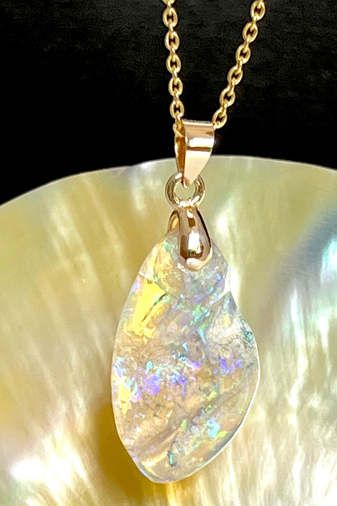 An absolutely stunning opal pendant featuring a soft droplet of Australian crystal opal cut and polished to reveal the wonderful colour and sand that reveals itself underneath. A rare one of a kind opal.