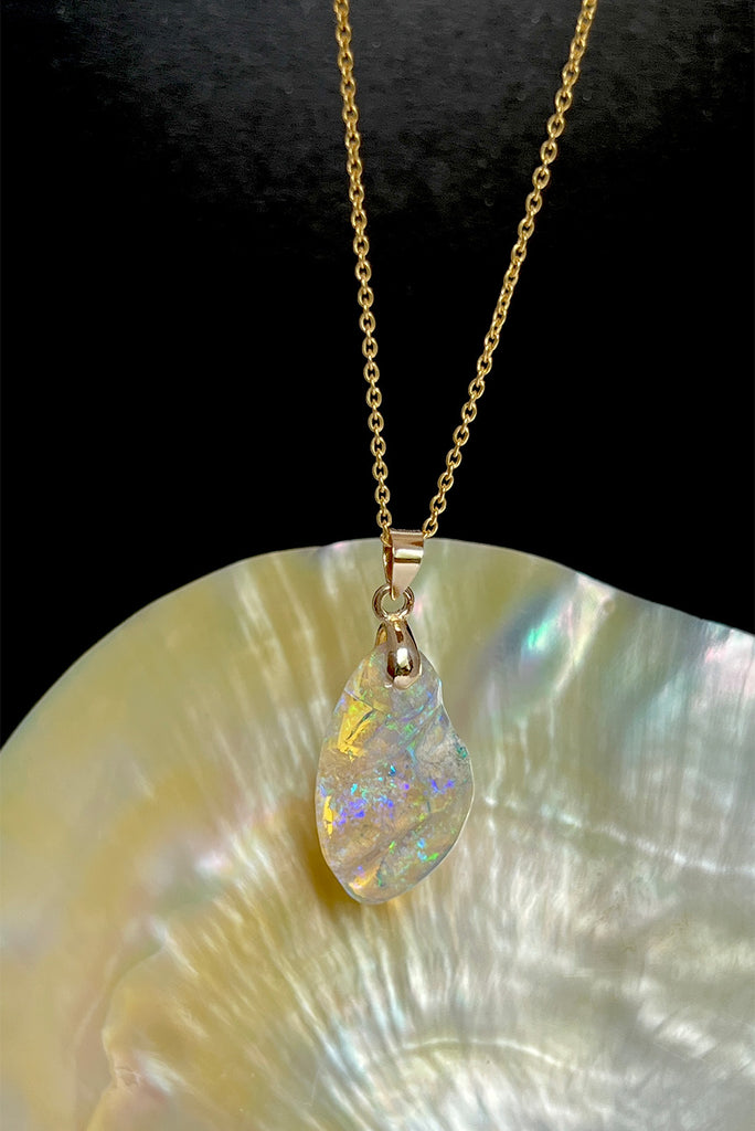 An absolutely stunning opal pendant featuring a soft droplet of Australian crystal opal cut and polished to reveal the wonderful colour and sand that reveals itself underneath. A rare one of a kind opal.