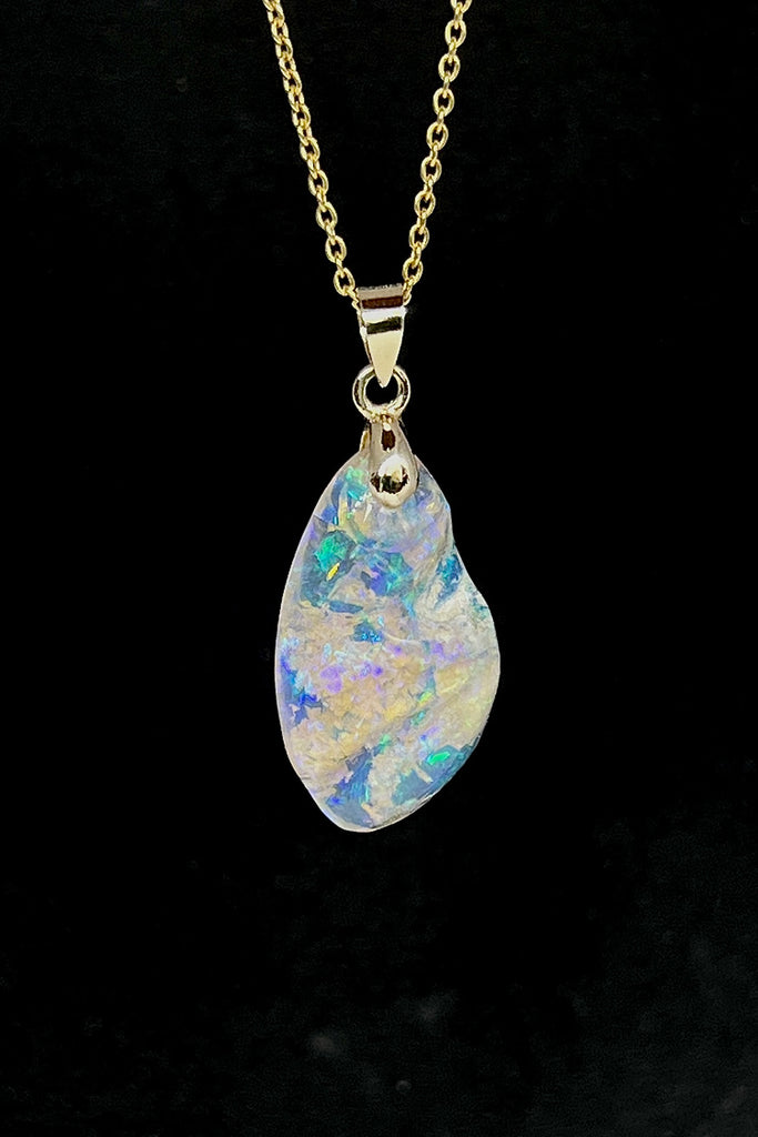 An absolutely stunning opal pendant featuring a soft droplet of Australian crystal opal cut and polished to reveal the wonderful colour and sand that reveals itself underneath. A rare one of a kind opal.