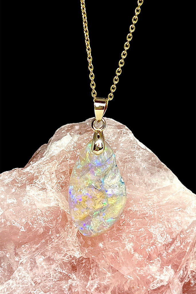 An absolutely stunning opal pendant featuring a soft droplet of Australian crystal opal cut and polished to reveal the wonderful colour and sand that reveals itself underneath. A rare one of a kind opal.