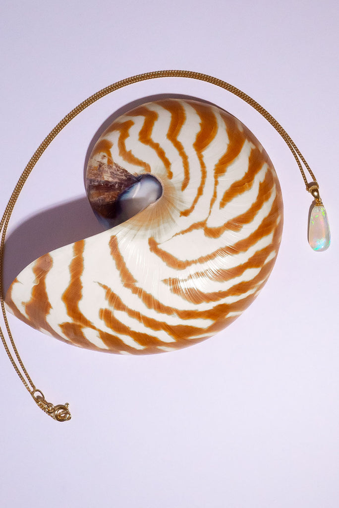 Elegant and mystical, this clear Australian crystal Opal pendant is shot through with bright green, sky blue and soft mauve, its all the colours of nature and the sky.