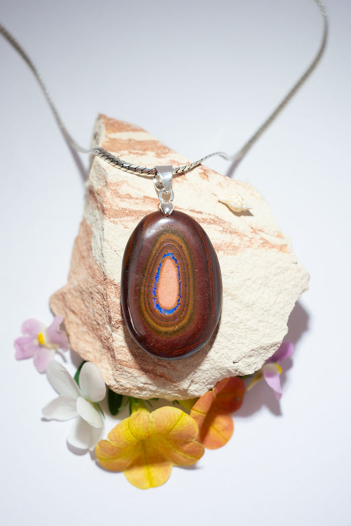 Like the walls of an outback gully as they slope down to a sparkling blue river below. This standout Australian Boulder Opal pendant was cut, polished and set in Noosa, Queensland from 100% Australian Opal.