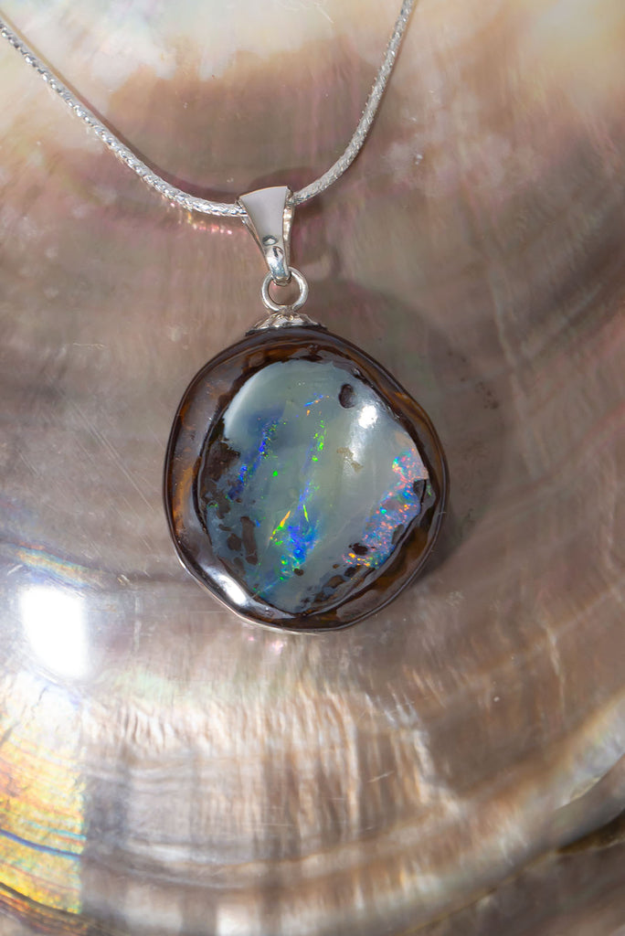 Discover a shimmering rainbow of colours in this magical Australian Boulder Opal piece.
