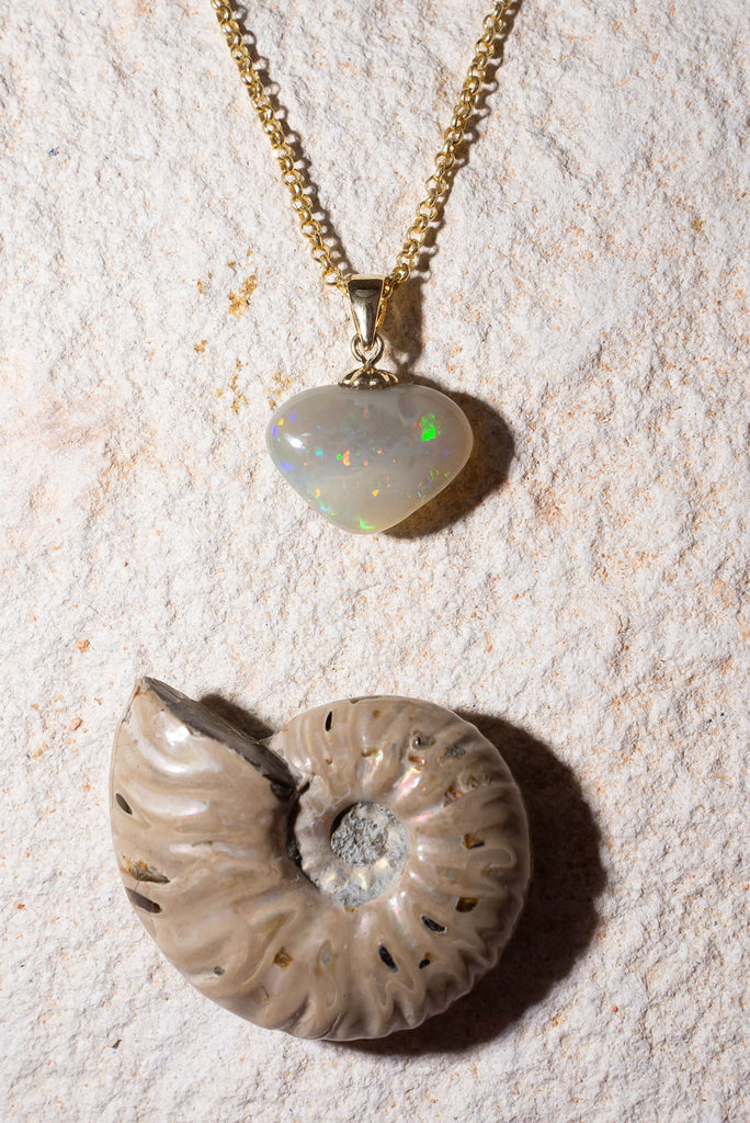 A stunning sparkly Opal heart pendant, the green, gold and blue flecks dance across the surface