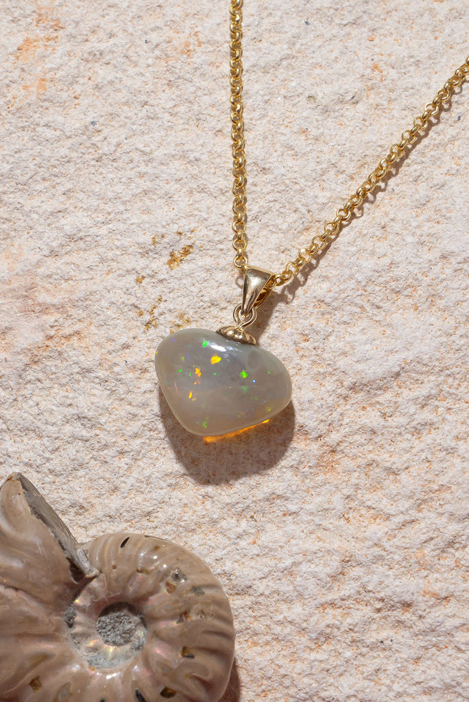 A stunning sparkly Opal heart pendant, the green, gold and blue flecks dance across the surface