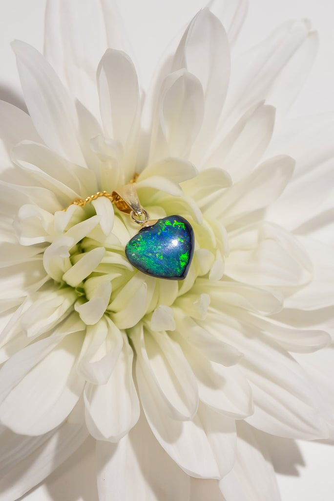 A perfect Australian black opal heart pendant, a view of ancient water swirling as an ocean of blue and green, it is quite magical