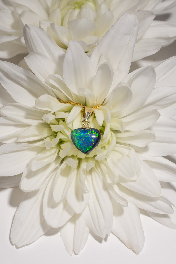 A perfect Australian black opal heart pendant, a view of ancient water swirling as an ocean of blue and green, it is quite magical