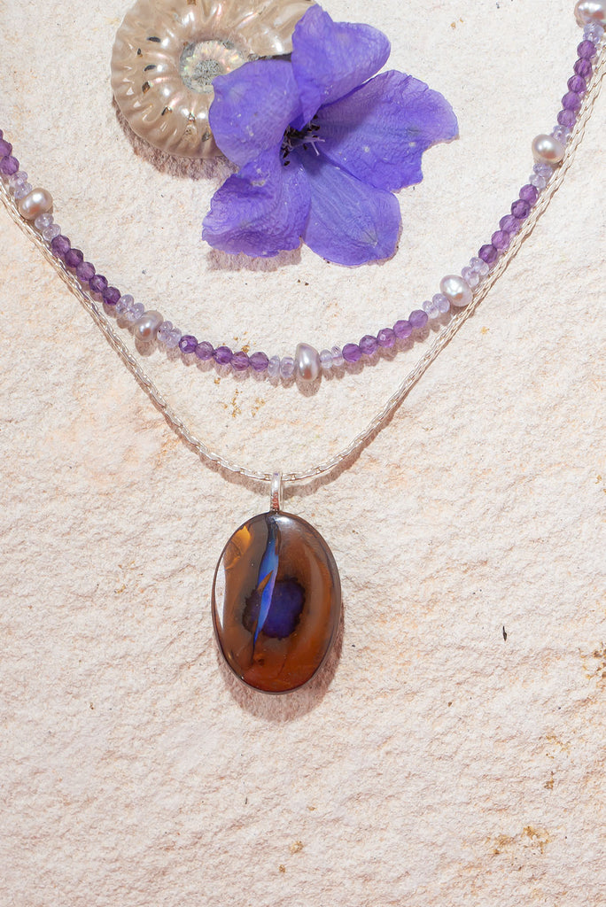 Like a flash of lightning across a desert landscape this unique Australian boulder opal pendant features a gorgeous bolt of deep indigo crystal with flashes of blue fire.