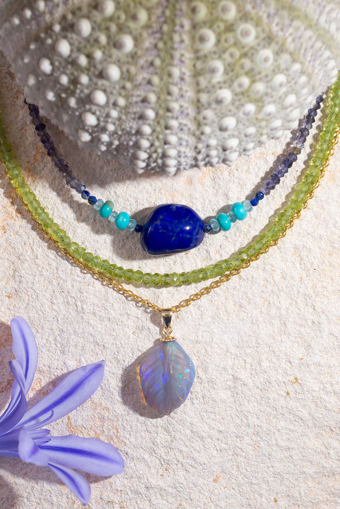 A beautiful carved opal in the shape of a leaf, the curve of this mysterious stone has been delicately hand carved and polished.