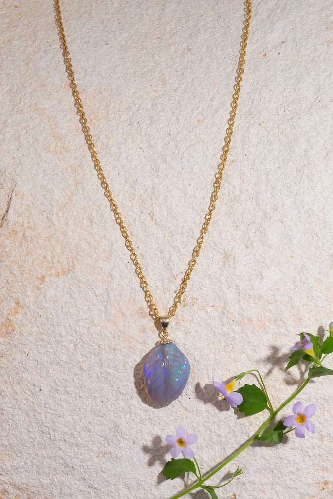 A beautiful carved opal in the shape of a leaf, the curve of this mysterious stone has been delicately hand carved and polished.
