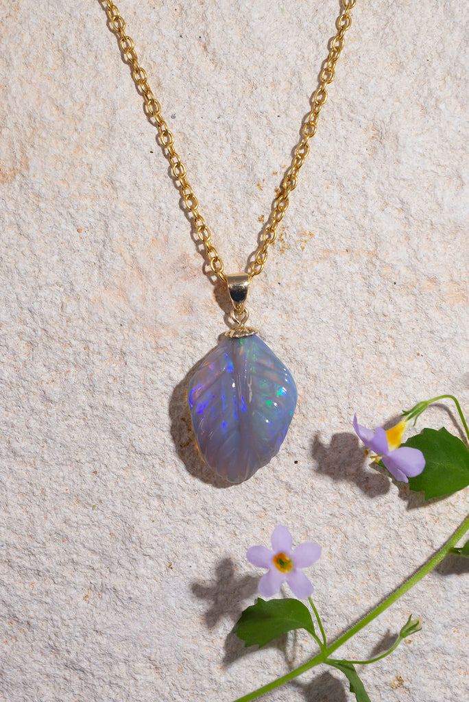 A beautiful carved opal in the shape of a leaf, the curve of this mysterious stone has been delicately hand carved and polished.