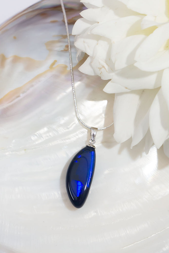 An absolute stunning blue black opal, a rolling flash of bright cobalt blue shows brightly at different angles, the mystery of ancient water brightly set in a stone from deep in the earth.