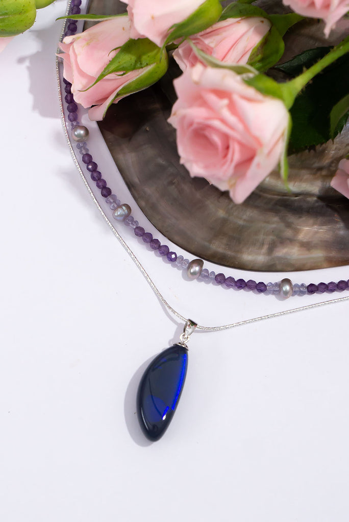 An absolute stunning blue black opal, a rolling flash of bright cobalt blue shows brightly at different angles, the mystery of ancient water brightly set in a stone from deep in the earth.