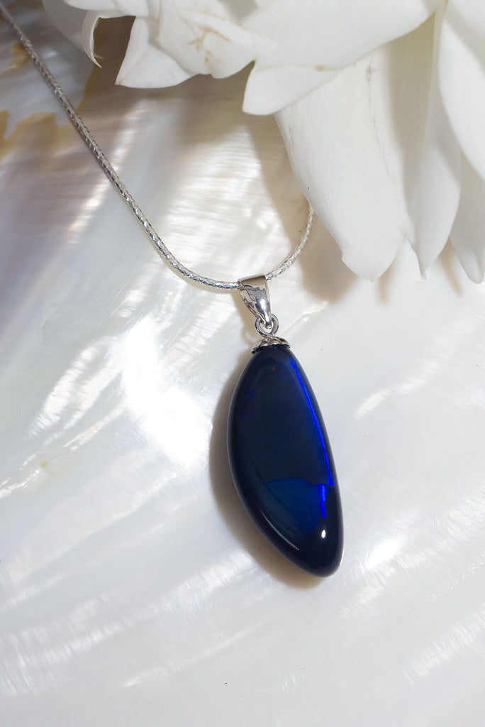 An absolute stunning blue black opal, a rolling flash of bright cobalt blue shows brightly at different angles, the mystery of ancient water brightly set in a stone from deep in the earth.
