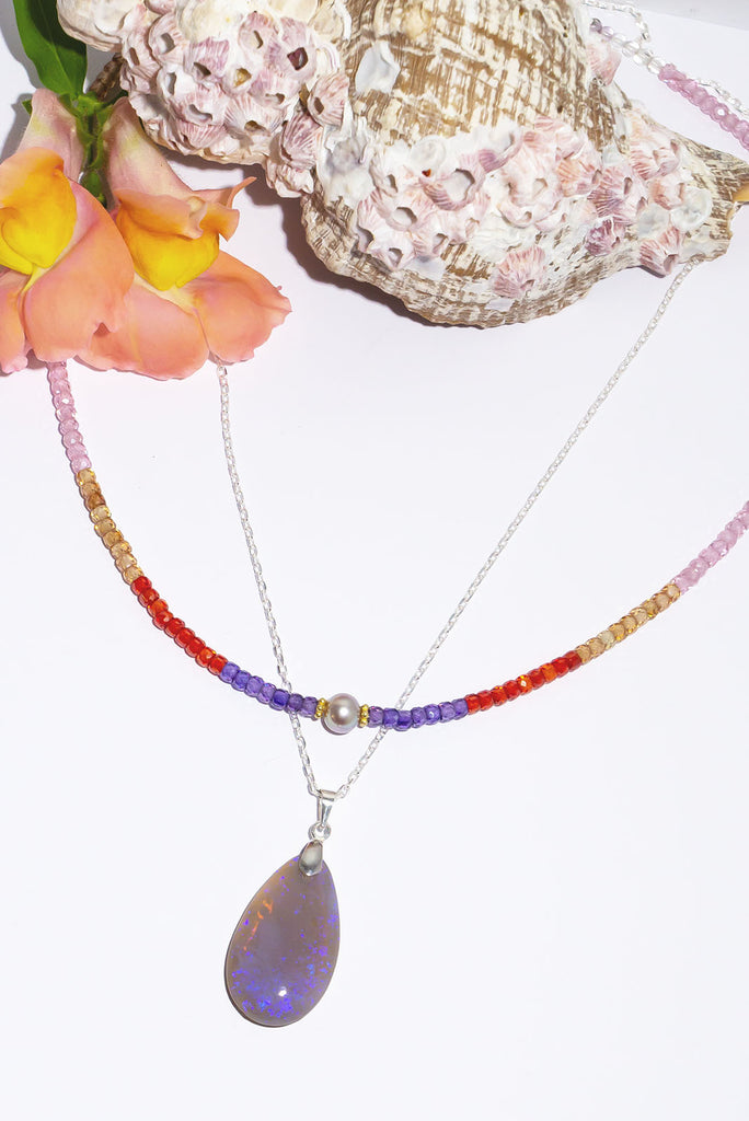 Magical swirls of blue & purple shimmer within this beautiful misty crystal pendant.