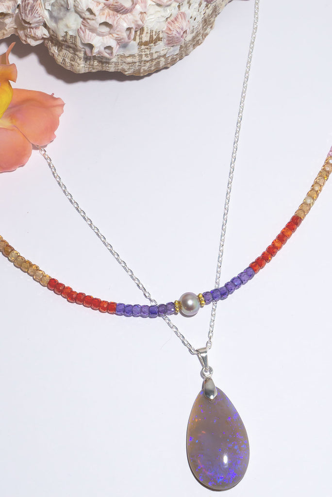 Magical swirls of blue & purple shimmer within this beautiful misty crystal pendant.