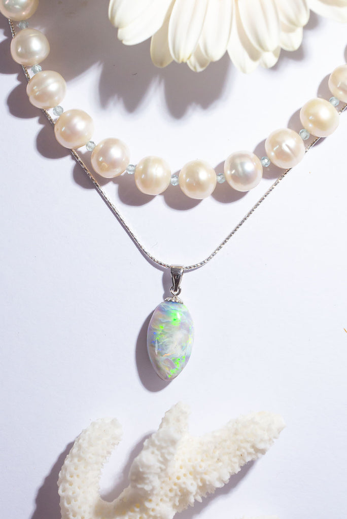 The enthralling colour play in this stunning solid Australian opal pendant is truly exceptional. Within this stone you will find a beautiful bright rolling green flash that needs no extra light to shine and a gorgeous overlay of glowing blue fire crystal opal.