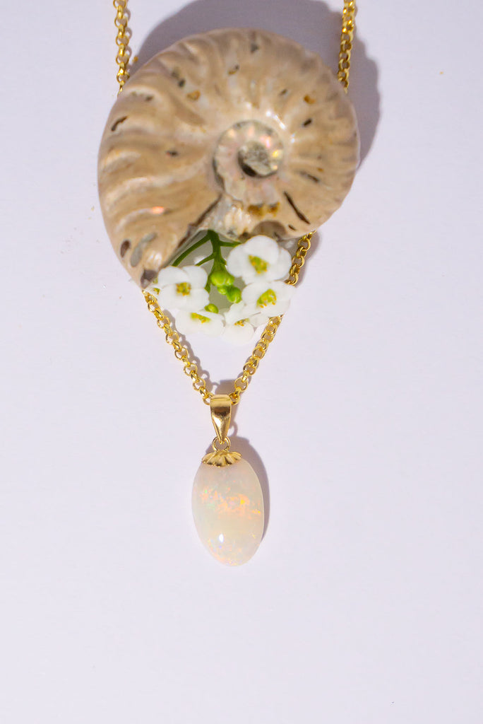 A tiny luminous droplet of pink flashes with blue, green and gold dancing inside. This pretty little opal pendant will look divine in sunlight.