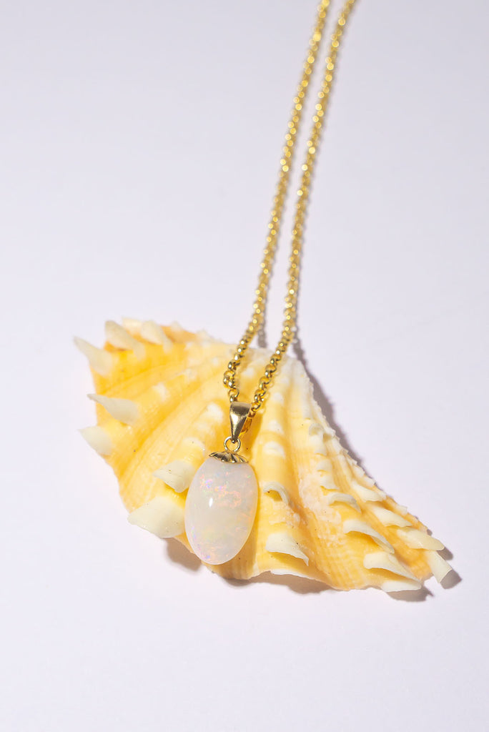 A tiny luminous droplet of pink flashes with blue, green and gold dancing inside. This pretty little opal pendant will look divine in sunlight.
