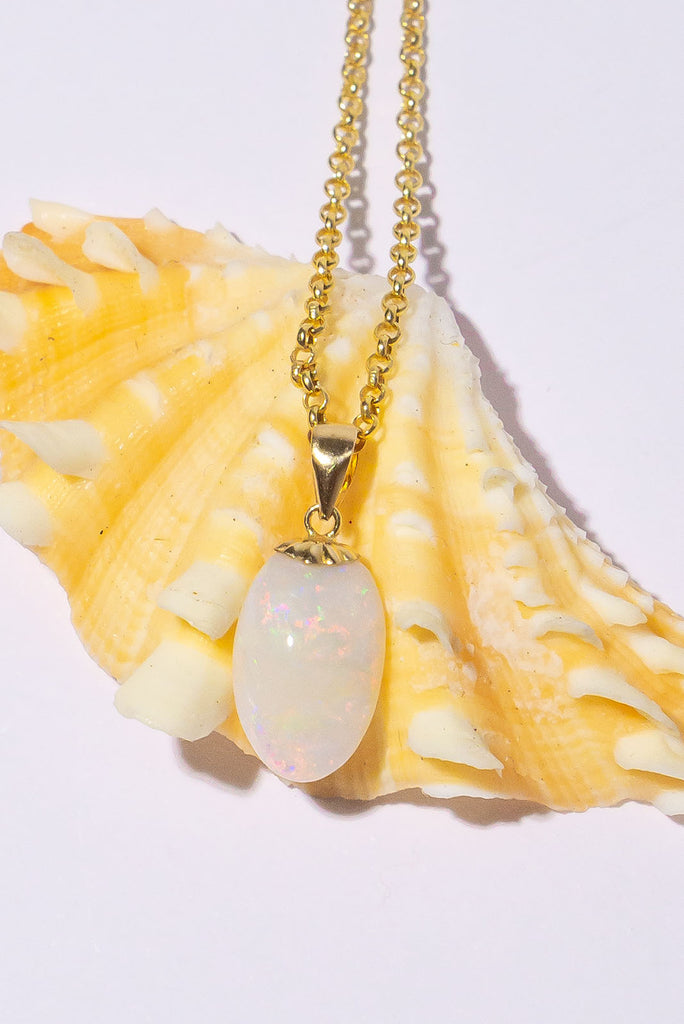 A tiny luminous droplet of pink flashes with blue, green and gold dancing inside. This pretty little opal pendant will look divine in sunlight.