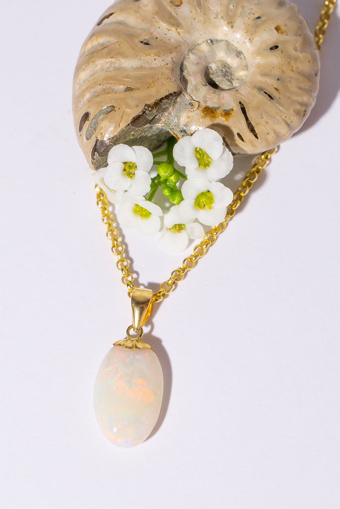 A tiny luminous droplet of pink flashes with blue, green and gold dancing inside. This pretty little opal pendant will look divine in sunlight.