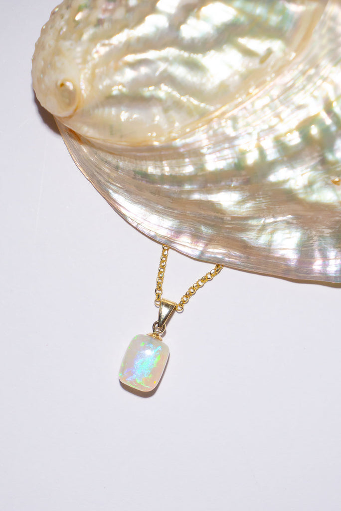 Bright blue flash and green sparkle, this crystal opal is a precious drop of ancient water silkily flowing through the stone.
