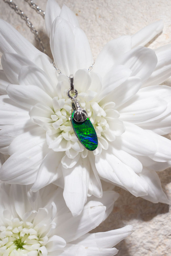 Petite in size but mighty in colour. This delicate Australian Black Opal pendant has an extraordinary green rolling colour flash reminiscent of a rainforest butterfly wing.