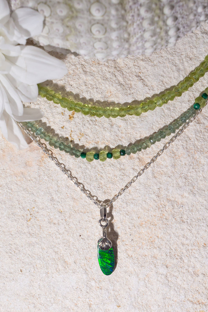 Petite in size but mighty in colour. This delicate Australian Black Opal pendant has an extraordinary green rolling colour flash reminiscent of a rainforest butterfly wing.