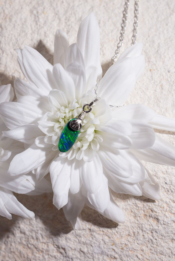 Petite in size but mighty in colour. This delicate Australian Black Opal pendant has an extraordinary green rolling colour flash reminiscent of a rainforest butterfly wing.