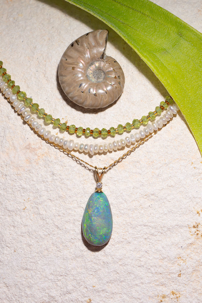 his pendant is the most beautiful semi black crystal Opal, it swirls with intense greens and blue visible at any angle.


9.9ct solid natural semi black Australian Opal.
Cut and polished into an elegant oval to best enhance the intense blue and green colours.
The pendant bail is 18k solid gold with a 1pt white natural diamond.