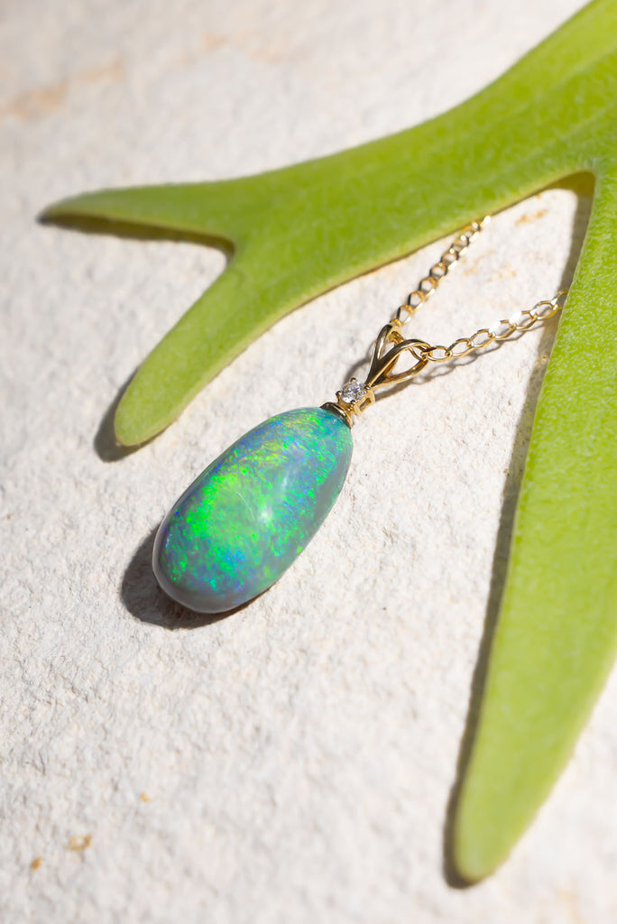 his pendant is the most beautiful semi black crystal Opal, it swirls with intense greens and blue visible at any angle.


9.9ct solid natural semi black Australian Opal.
Cut and polished into an elegant oval to best enhance the intense blue and green colours.
The pendant bail is 18k solid gold with a 1pt white natural diamond.