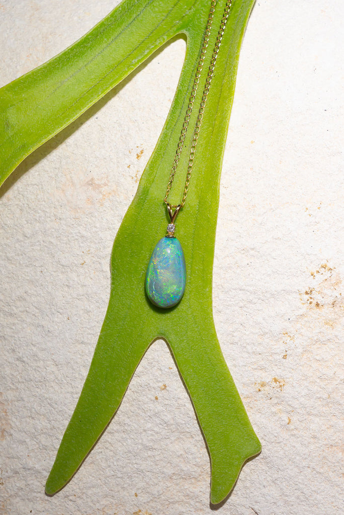 his pendant is the most beautiful semi black crystal Opal, it swirls with intense greens and blue visible at any angle.


9.9ct solid natural semi black Australian Opal.
Cut and polished into an elegant oval to best enhance the intense blue and green colours.
The pendant bail is 18k solid gold with a 1pt white natural diamond.