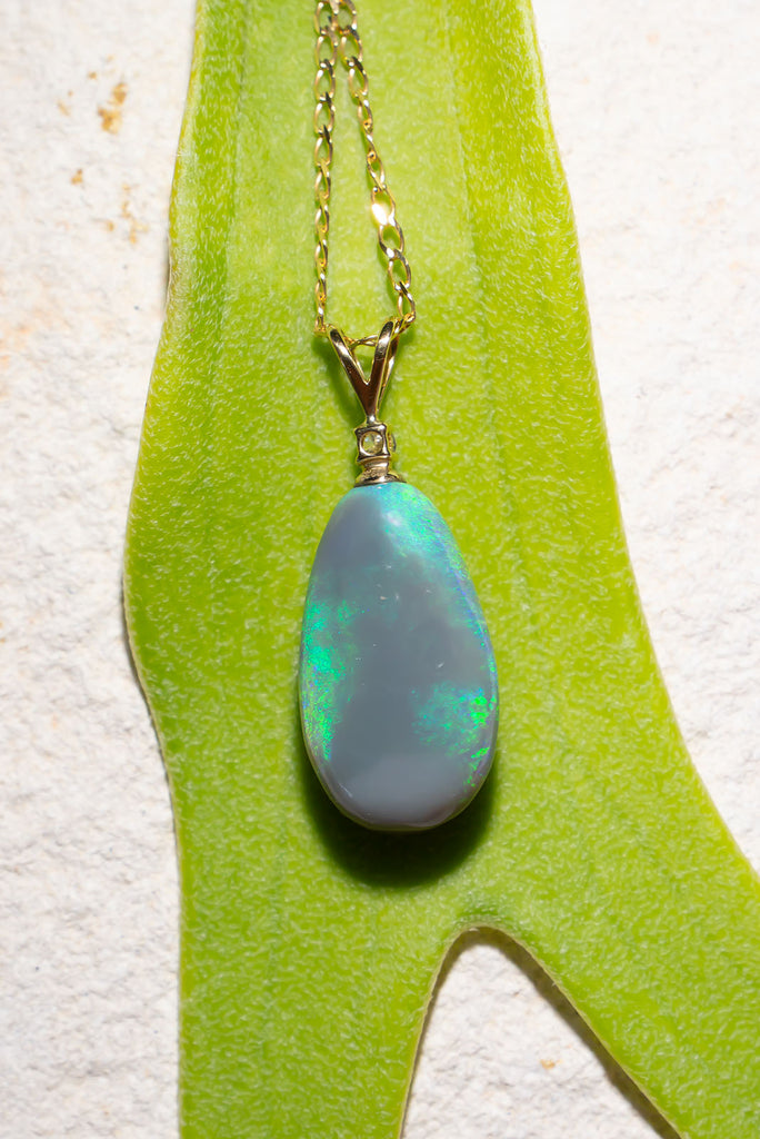 his pendant is the most beautiful semi black crystal Opal, it swirls with intense greens and blue visible at any angle.


9.9ct solid natural semi black Australian Opal.
Cut and polished into an elegant oval to best enhance the intense blue and green colours.
The pendant bail is 18k solid gold with a 1pt white natural diamond.