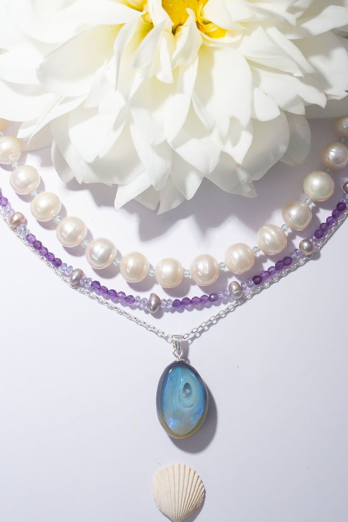 A swirling whirl of shimmering indigo fire in black and grey opal.