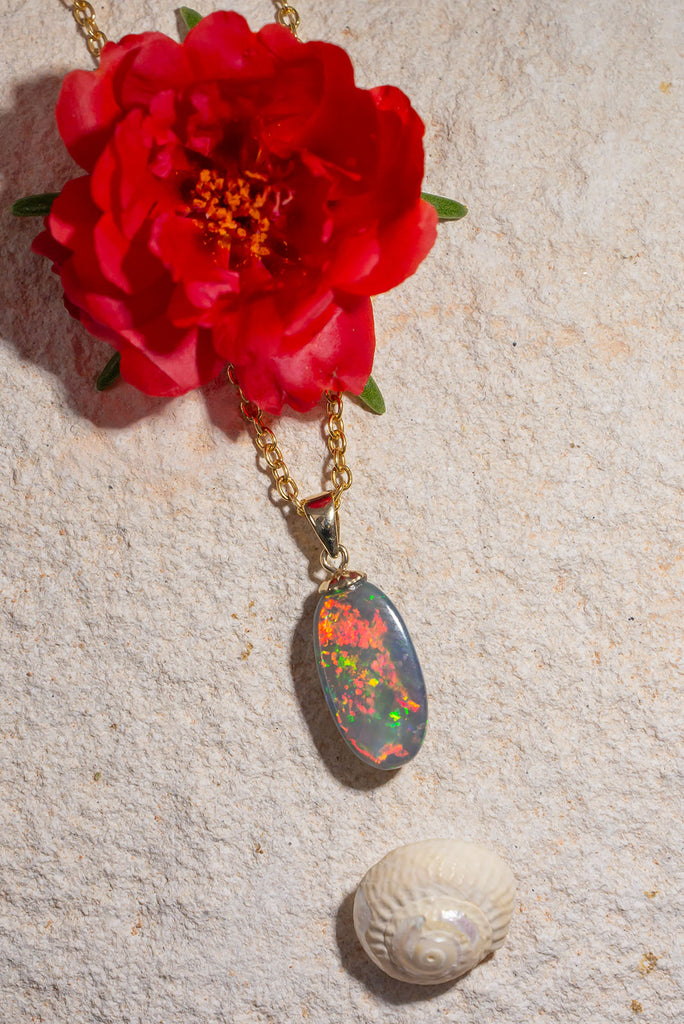 An Australian outback sunset in an opal stone, with all the true colours of black Opal, red, orange, gold and green. This stunning opal pendant is a truly special and unique piece.
