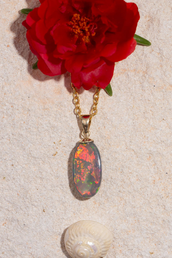 An Australian outback sunset in an opal stone, with all the true colours of black Opal, red, orange, gold and green. This stunning opal pendant is a truly special and unique piece.
