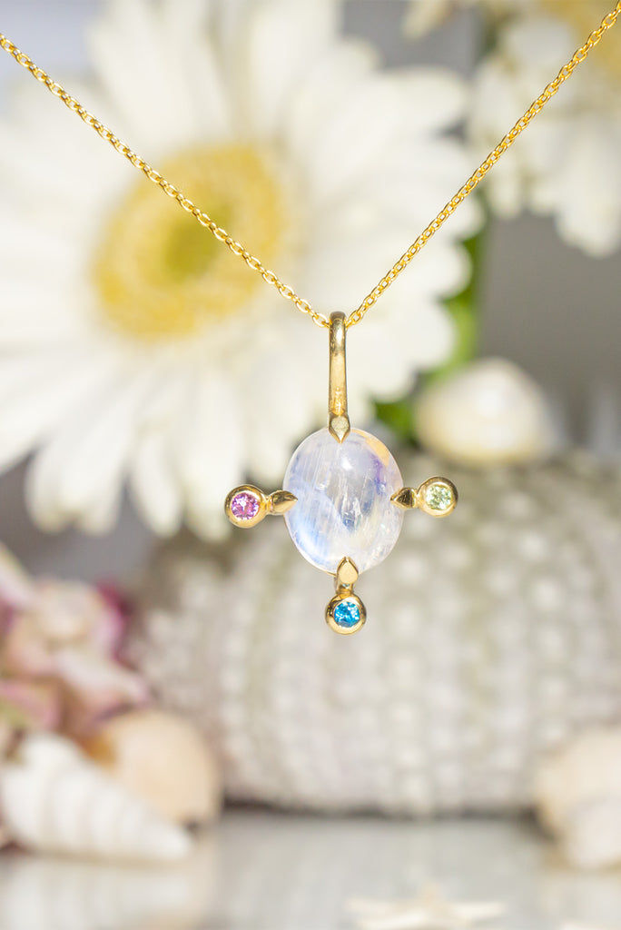 The pendant and chain are 9ct gold vermeil on a base of 925 silver, the gold is 2.5microns thick so will never rub or discolor An oval cabochon cut top quality Moonstone gemstone set in 9ct gold vermeil. Side stones are Sapphires.