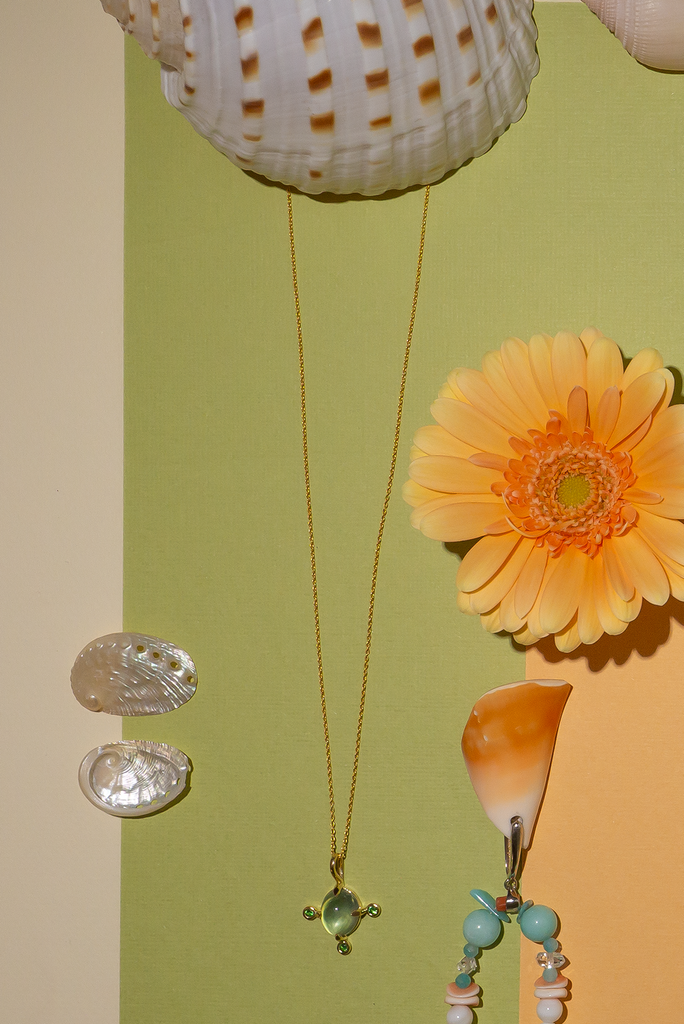 The pendant and chain are 9ct gold vermeil on a base of 925 silver, the gold is 2.5microns thick so will never rub or discolor An oval cabochon cut top quality Prehnite gemstone set in 9ct gold vermeil. Side stones are Sapphires