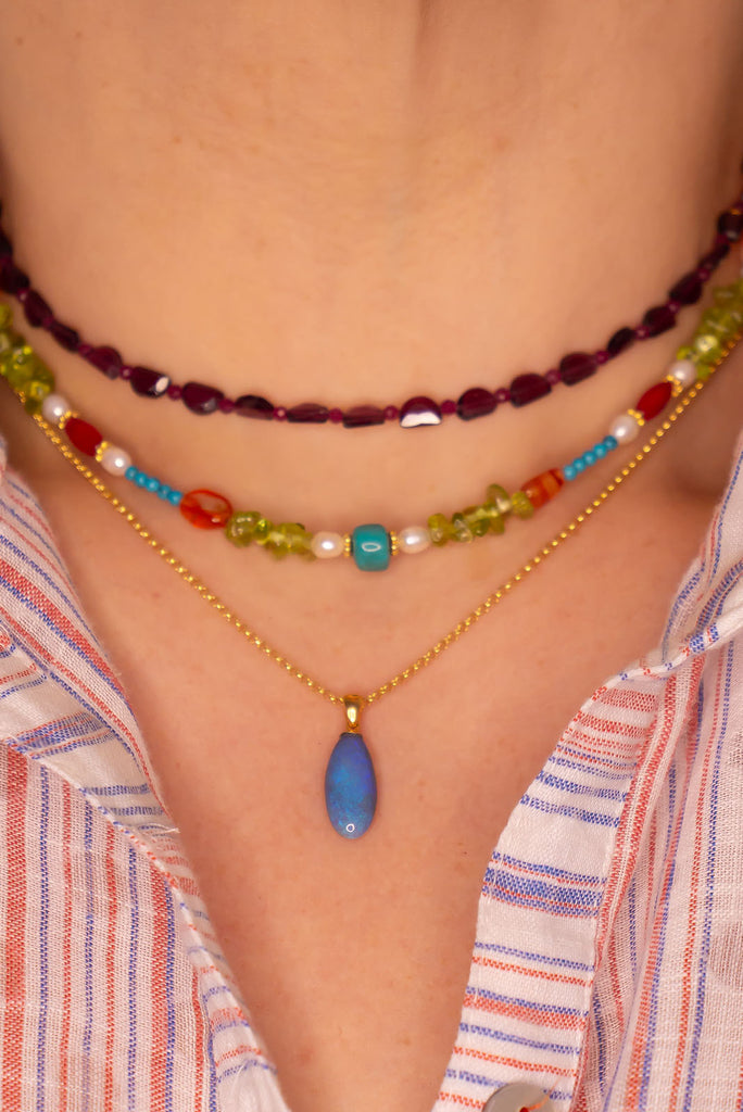An elegant droplet of blue, this semi black pendant is perfectly chic and softly feminine.