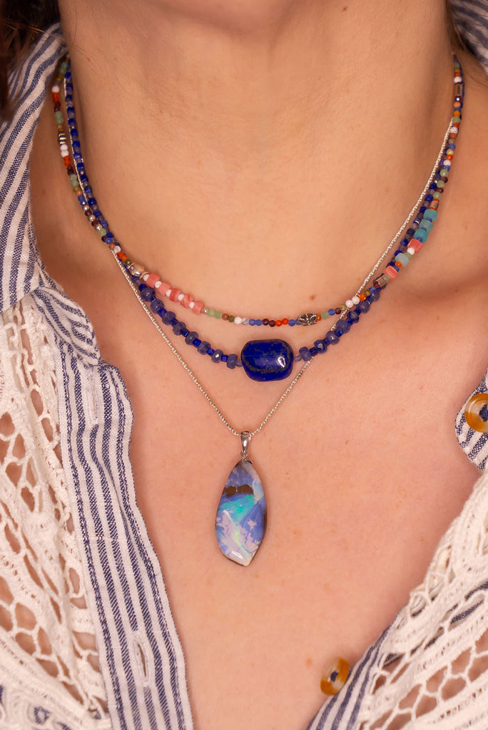 An organic natural piece featuring a small clear jelly opal detail on one side that reveals what is underneath.