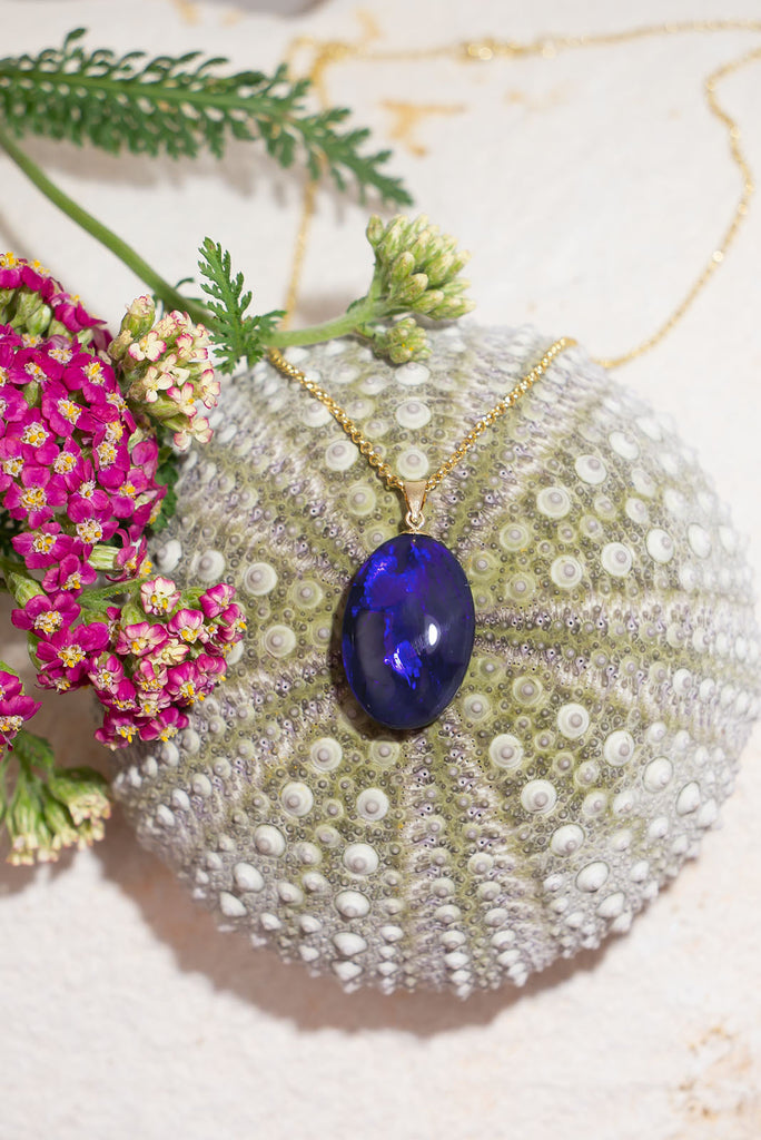 This opal pendant is an absolute stunner, a rolling flash of bright cobalt blue with tones of deep purple, the mystery of ancient water set in a stone from deep in the earth.