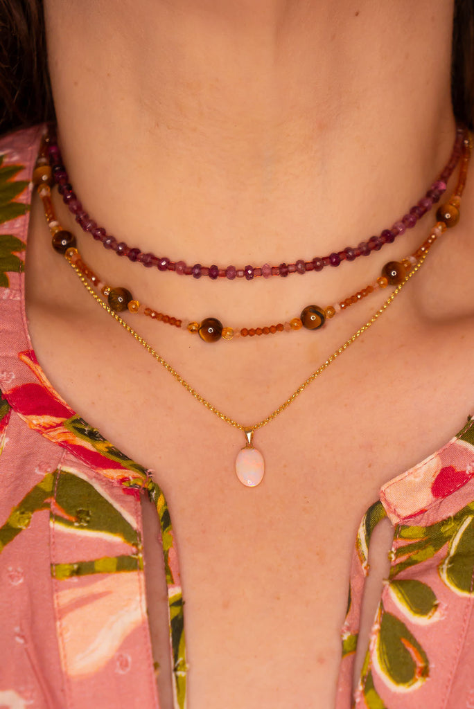 A tiny luminous droplet of pink flashes with blue, green and gold dancing inside. This pretty little opal pendant will look divine in sunlight.