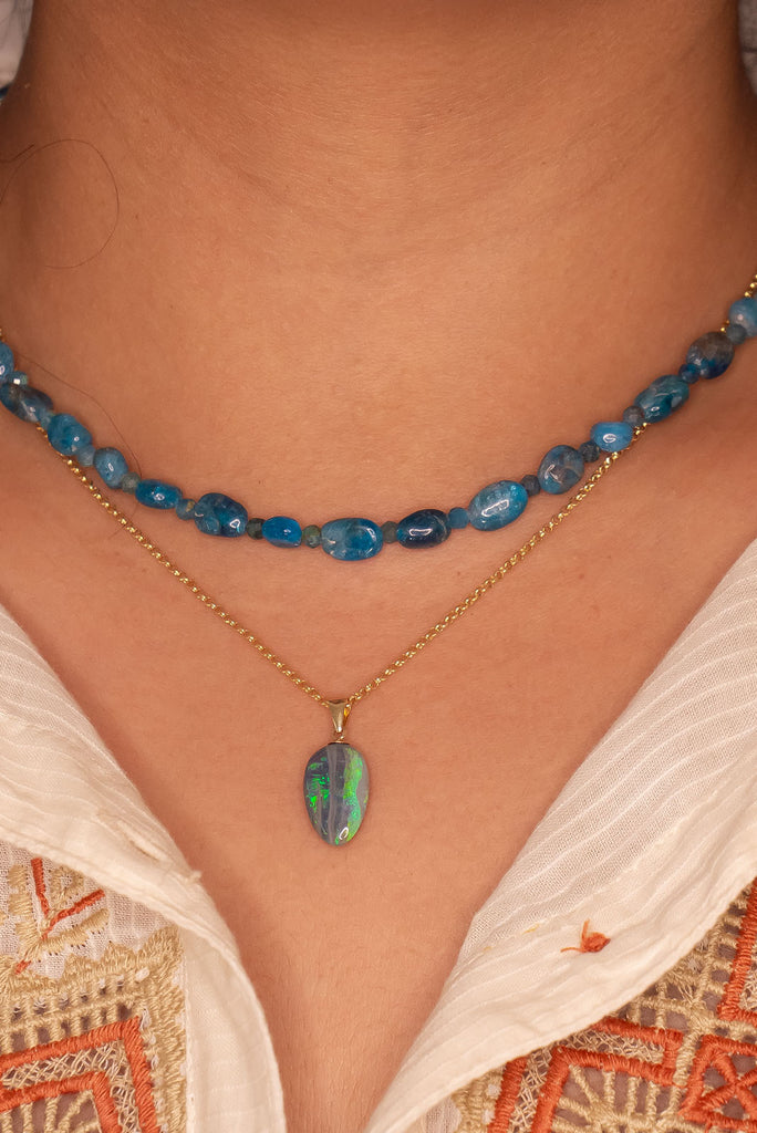 This unusual semi black opal has really interesting detail, it resembles an ancient road travelling across the landscape of green and blue.